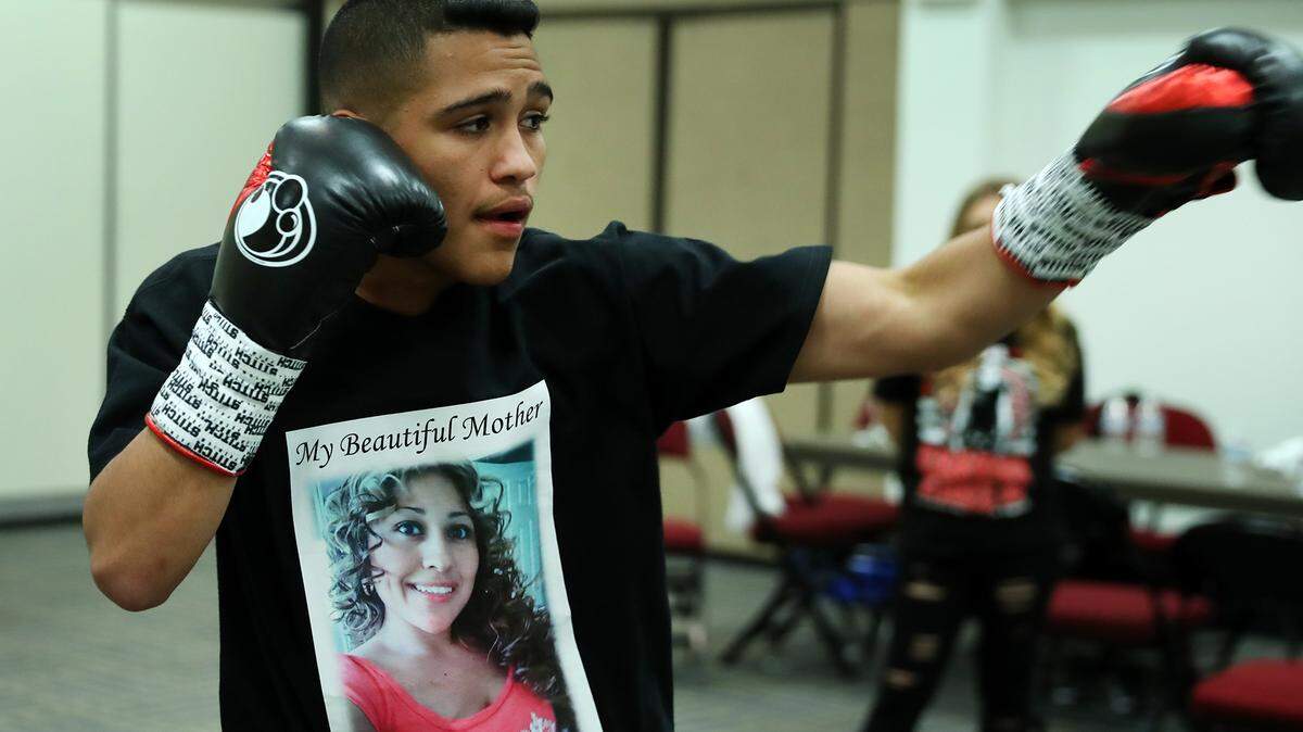 Gabriel Flores Jr. warms up for a fight while wearing a shirt to honor is mom, Juanita Maldonado, who was shot and killed in 2013.