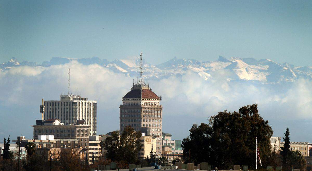 The downtown Fresno skyline before the backdrop of a snowcapped Sierra Nevada in December 2009.