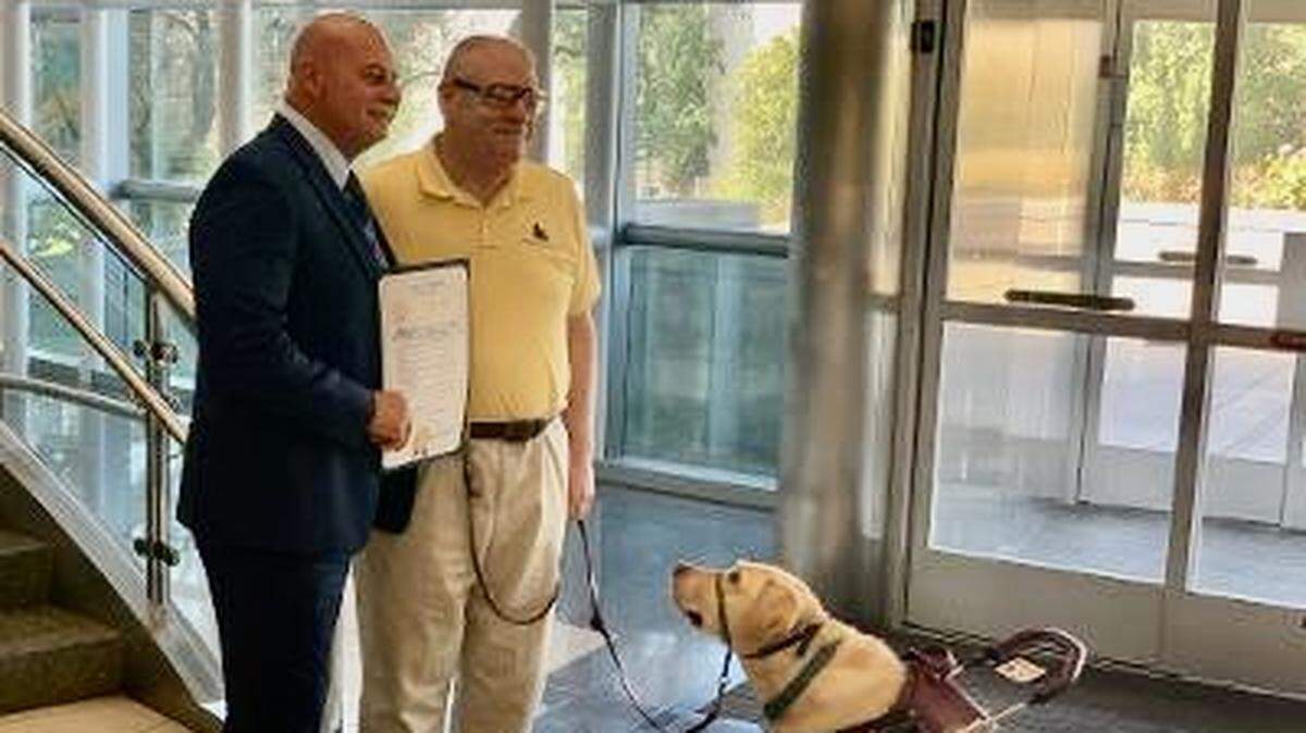 Fresno Mayor Jerry Dyer and Ed Crane and Zern with the proclamation for International Assistance Dog Week.
