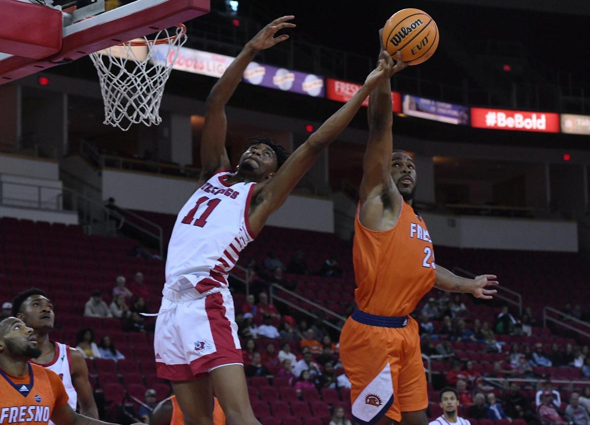Fresno State’s Isaih Moore, left, loses the rebound to Fresno Pacific’s Darrin Person Jr., right, Monday, Nov. 7, 2022 in Fresno. The Bulldogs beat the Sunbirds with a final score of 69-56.
