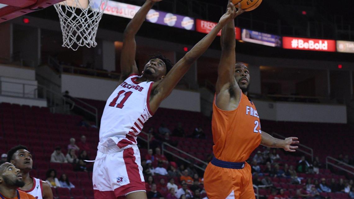 Fresno State center Isaih Moore, left, fights for a rebound with Fresno Pacific’s Darrin Person Jr., right, Monday, Nov. 7, 2022 in Fresno. The Bulldogs beat the Sunbirds 69-56.