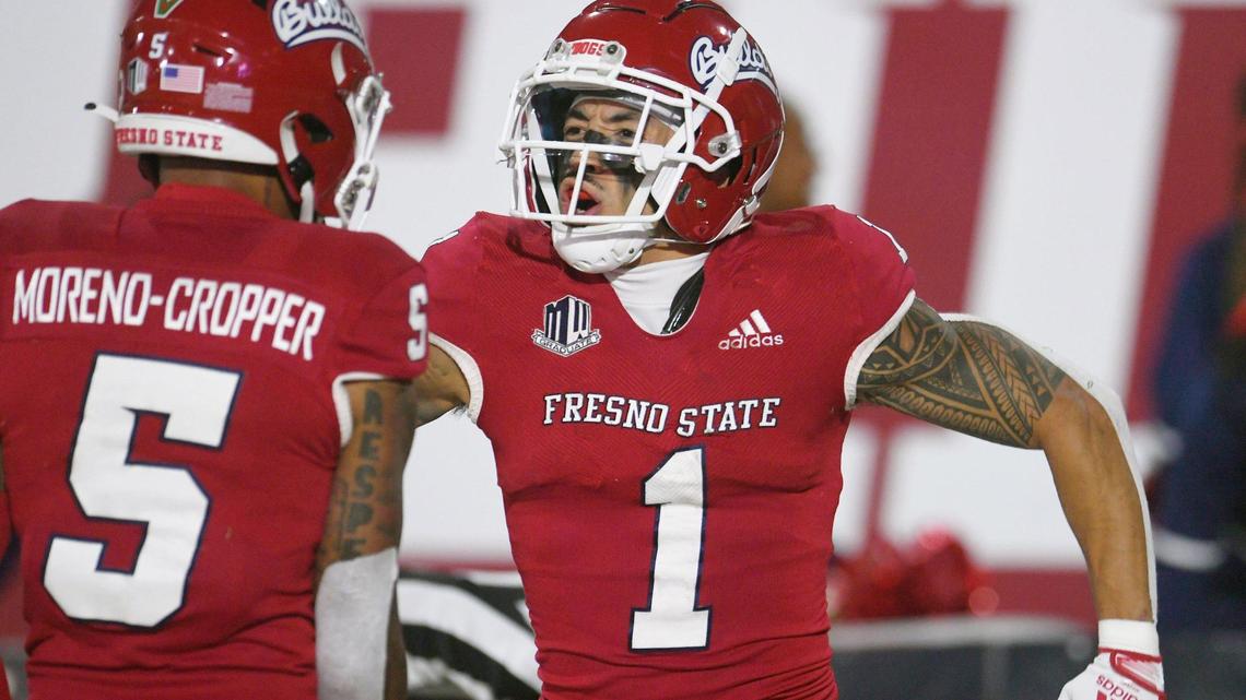 Fresno State wideout Nikko Remigio, right, celebrates his touchdown against Wyoming with Jalen Moreno-Cropper, Friday, Nov. 25, 2022 in Fresno. The Bulldogs won 30-0.