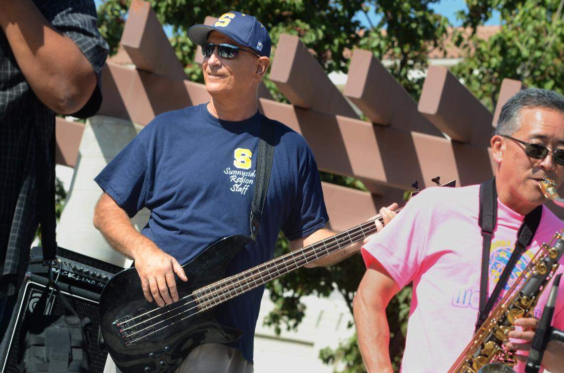 Sunnyside High School Principal Tim Liles, left, plays bass in faculty band Los Gatos Locos during a 2013 homecoming concert at the school’s quad.