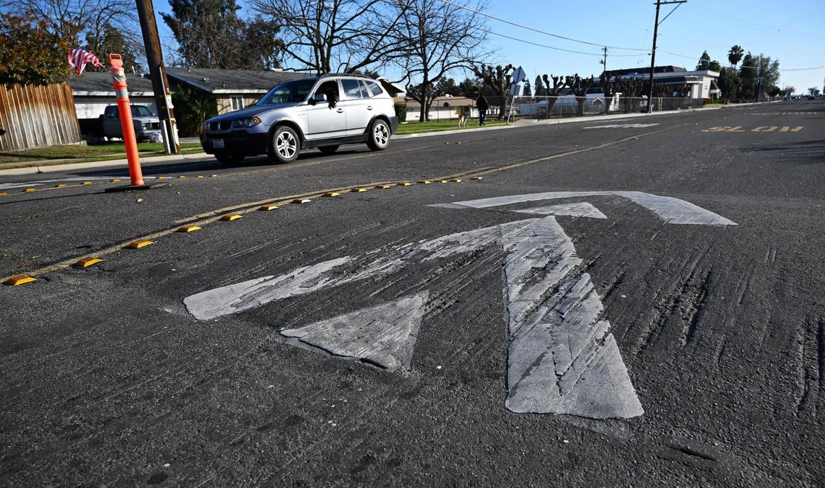 Gouges in the asphalt show wear where traffic encounters three sets of speed bumps along Chestnut Ave. between Gettysburg and Ashlan avenues Tuesday, Jan. 9, 2024 in Fresno.