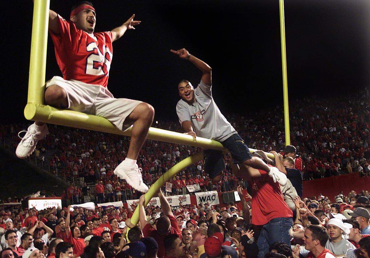 Fresno State fans flood the field Sept. 2 after the Bulldogs defeat Oregon State 44-24 in a nationally televised football game Sept. 2, 2001. Oregon State was the preseason national championship favorite according to Sports Illustrated, but couldn’t contain Fresno State quarterback David Carr and wide receiver Rodney Wright. Fans tore down the goalpost, prompting school officials to end a longtime tradition of allowing people on the field after games.