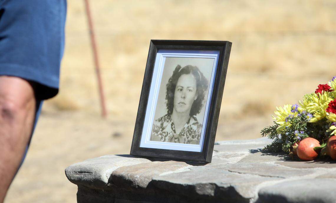 A portrait of María Rodríguez Santana rests atop a memorial marker with the names of the 32 people who died in a 1948 airplane crash at Los Gatos Canyon.