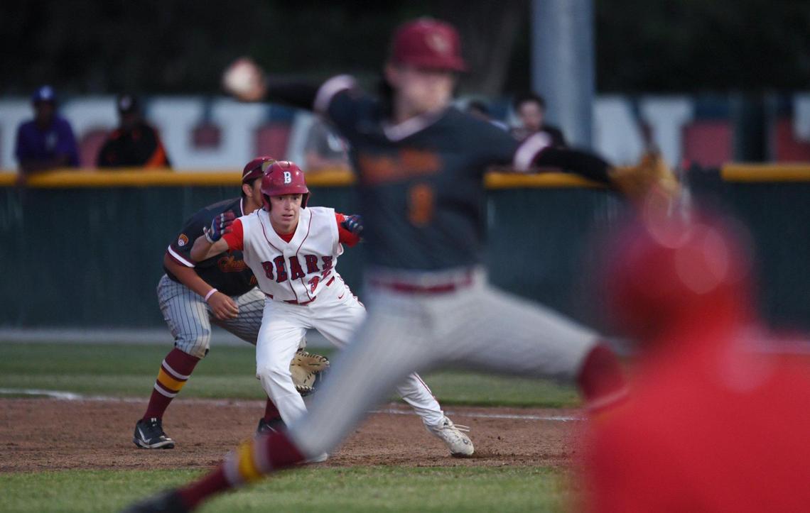Buchanan’s Sam Luna, background, leads off first base as Clovis West’s Tyler Patrick pitches in the third game of a three-game series Friday, May 6, 2022 in Clovis.