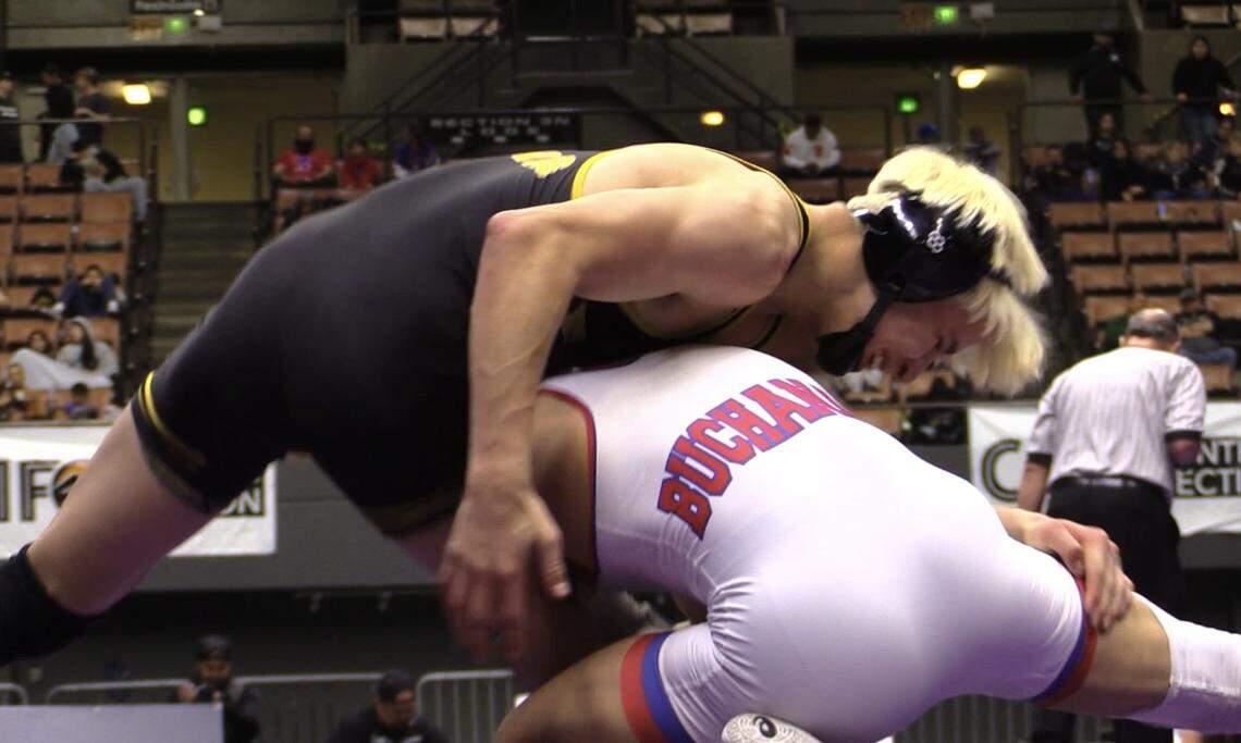 CJ Huerta of Buchanan wrestles Caleb Rivas of Golden West in the 122 pound division at the Central Section Masters at Selland Arena in Fresno, California on Saturday, Feb. 17, 2024.
