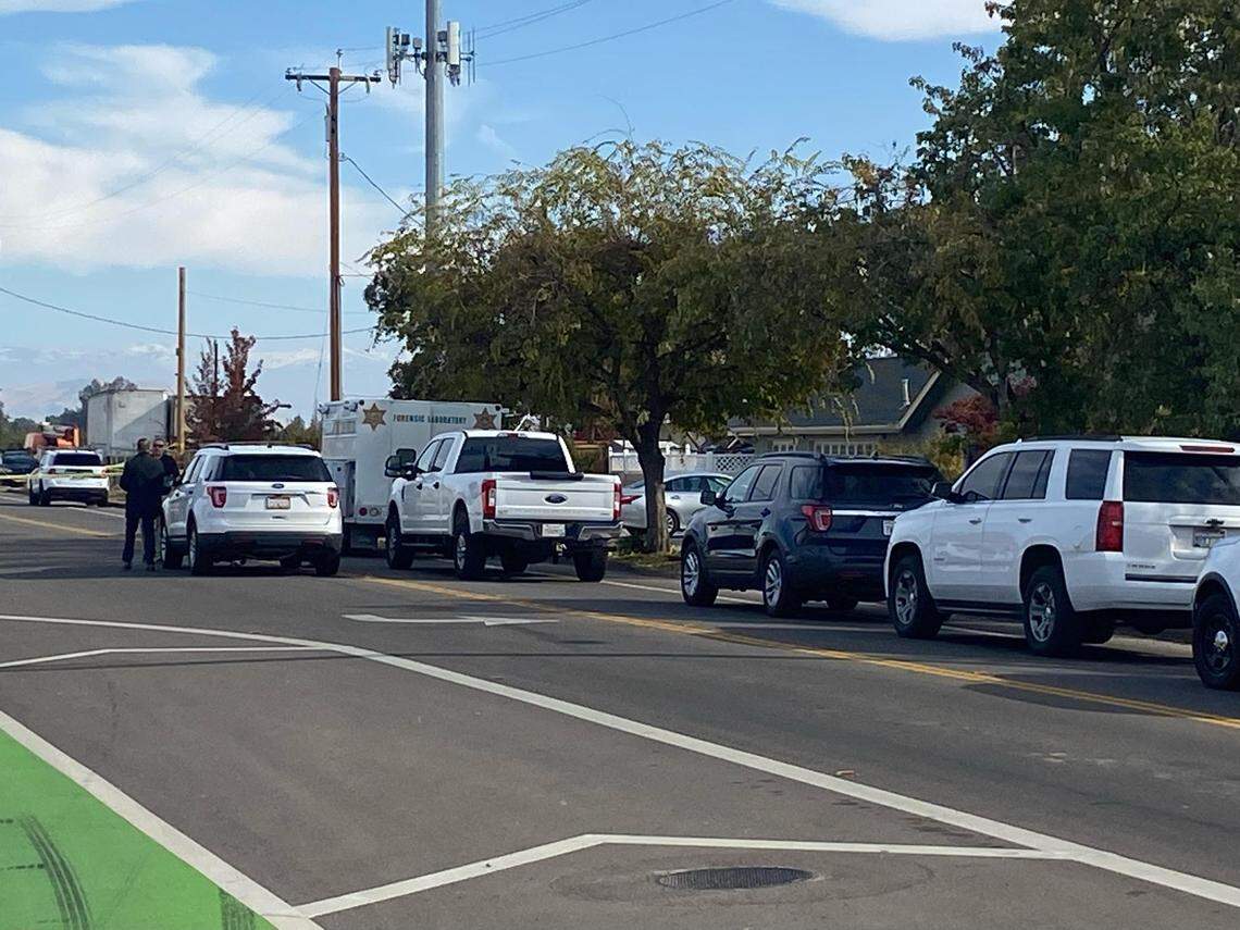 Law enforcement responds to a home where the woman was found dead in the yard on Thursday, Nov. 17, 2022.