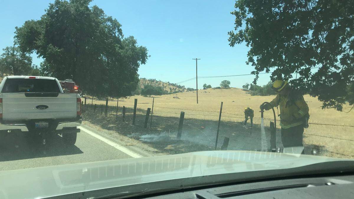 Cal Fire cleans up a grass fire on Tollhouse Road in Clovis Wednesday, May 19, 2021. The fire, which had the potential to spread quickly in dry grasses and blustery winds, was put out by passers-by.