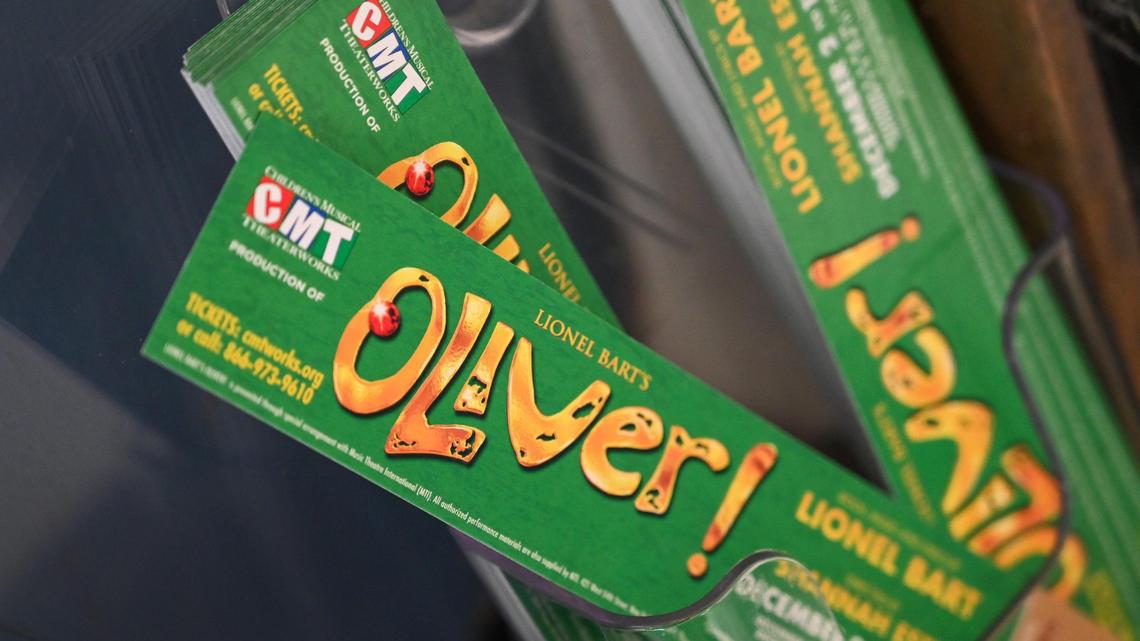 Bookmark cards advertising Children’s Musical Theaterworks’ Oliver! show sit near the company’s ticket booth at the Veterans Memorial Auditorium in Fresno on Thursday, Dec. 15, 2022. Fresno teachers recently walked a theater full of students out of the production during the middle of the show because they felt the content was inappropriate.