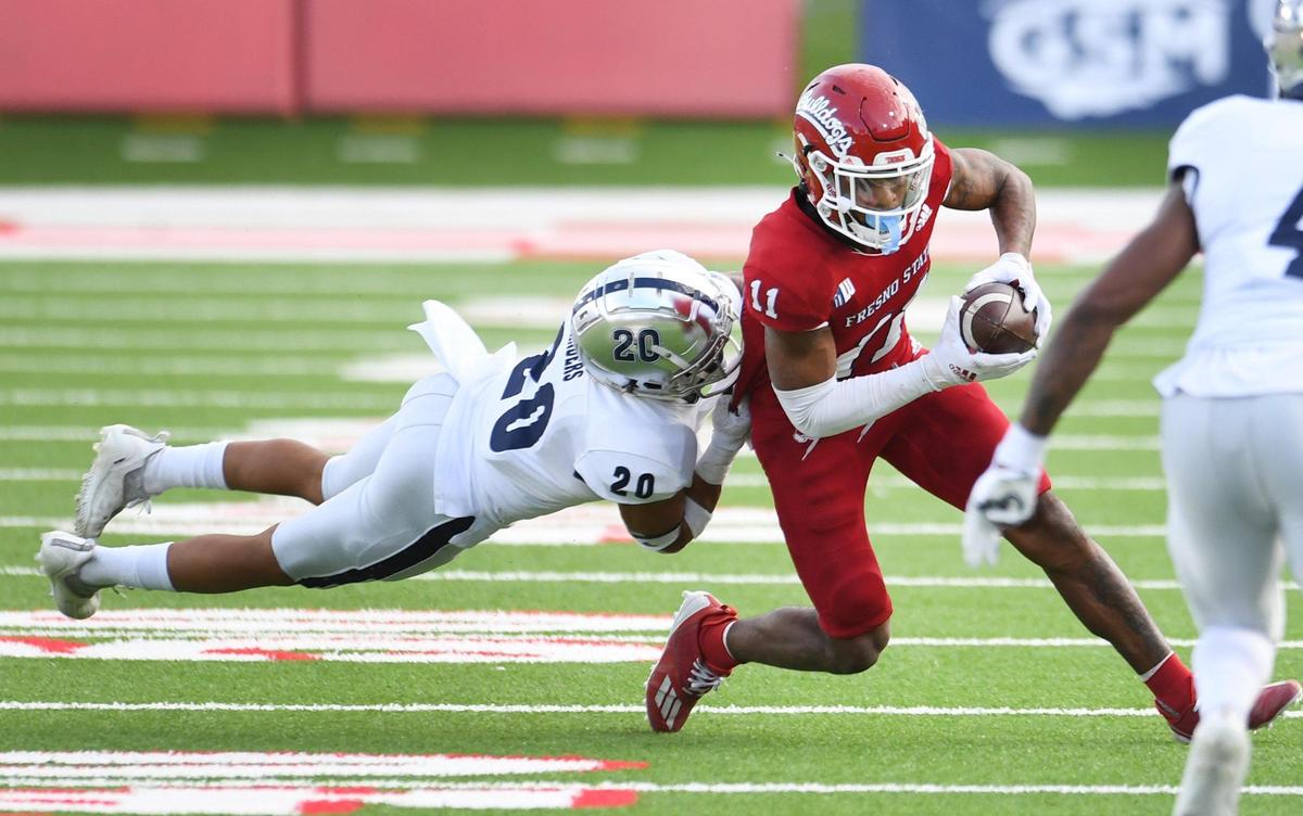 Fresno State’s Josh Kelly turns up field as he’s hit by Nevada’s Bentlee Sanders on a pass play during their game at Bulldog Stadium on Saturday, Oct. 23, 2021.