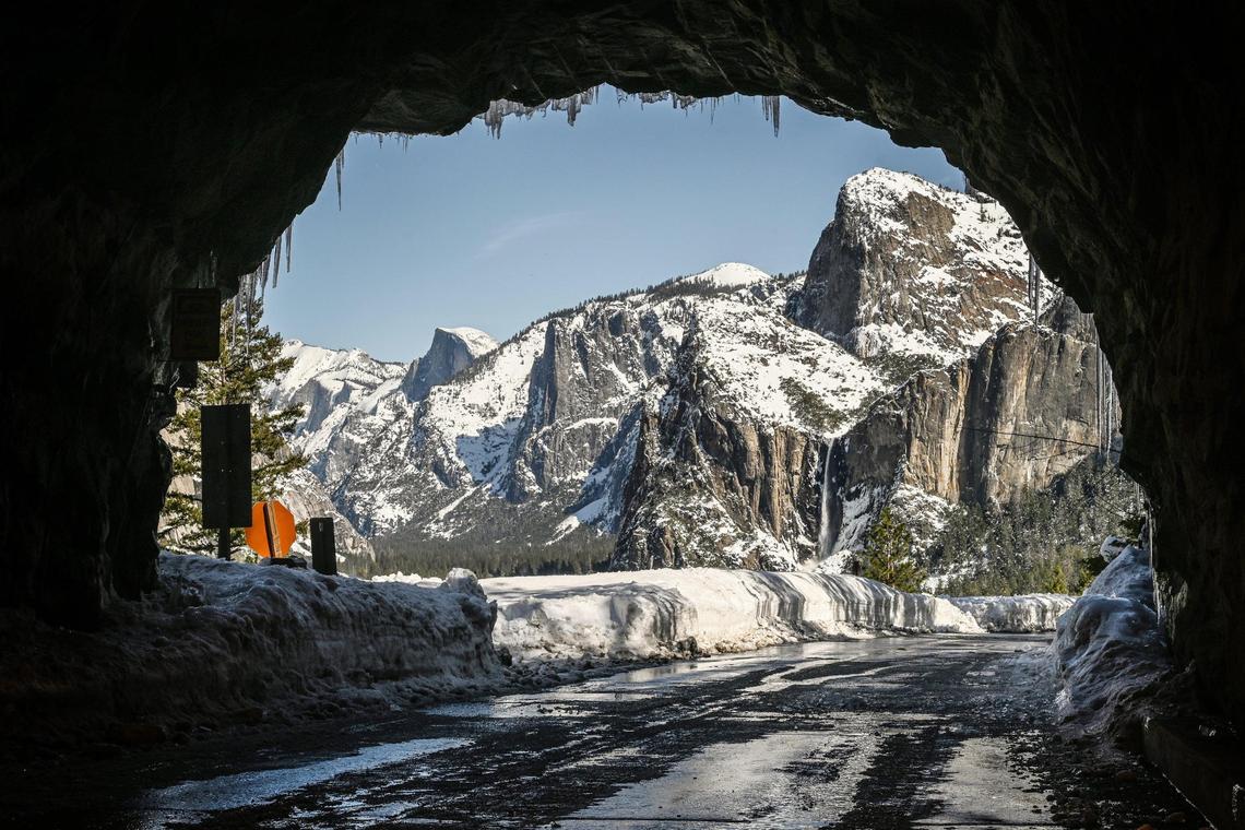 Yosemite’s iconic tunnel view unveils an unusually quiet snowy winter scene with banks piled high with snow and ice covering many of the roadways on Friday, March 3, 2023. The park has closed indefinitely due to recent heavy snowfall.