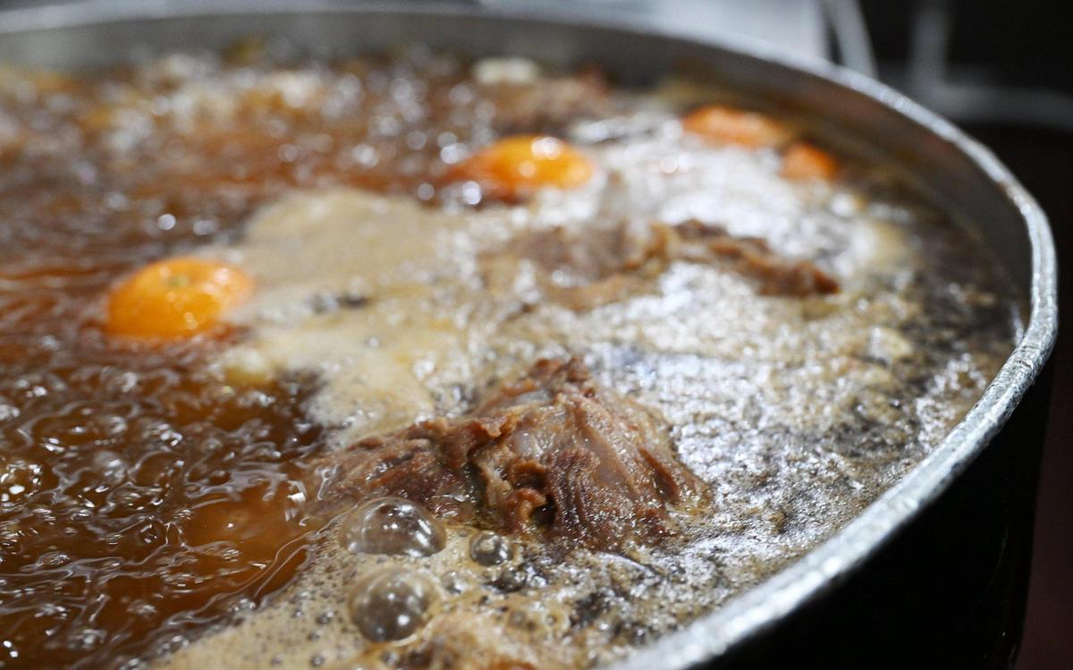 Carnitas simmers on the stovetop at the newly opened Toledo’s Mexican Restaurant at Cedar and Nees avenues in Fresno.