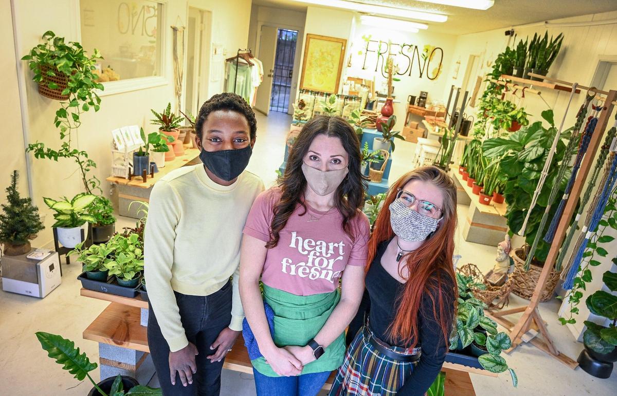 Alyssa Ndombeson, from left, of Good Fill, stands with Kelly Replogle of Let it Grow and Anna Lackey of The Book Bus Fresno in Replogle’s plant shop in Fresno on Friday, Jan 8, 2022. Replogle has welcomed the other small businesses into her shop to create a mini business incubator.