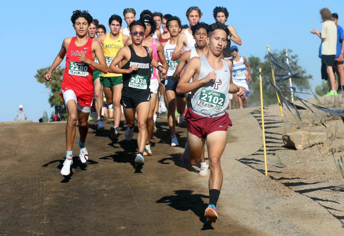 Matilda Torres High sophomore Benjamín Fernández leads a pack of runners during the Rob Brenner championship race of the 44th ASICS Clovis Invitational at Woodward Park on Oct. 7, 2023. Fernández placed 31st in 15:37.3.