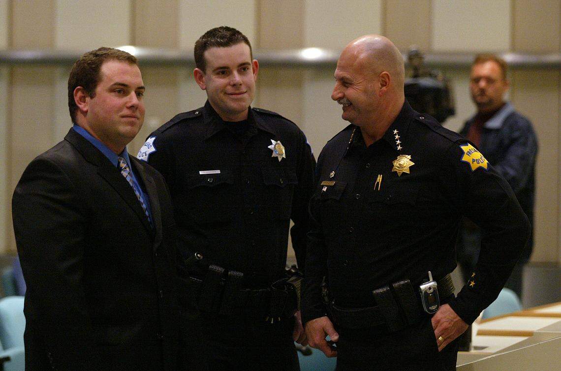 In January 2007 Fresno police officer Trevor Shipman, center, was one of two officers (along with Daniel Messick, left) honored by the city at a ceremony at City Hall. Chief Jerry Dyer, right, chats with the officers, who were ambushed by a gunman while responding to a call in October 2006.