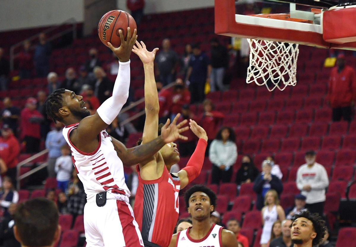 Fresno State’s Jordan Campbell, left, takes his shot covered by New Mexico’s Javonté Johnson, right, Monday, Feb. 28, 2022 in Fresno. Fresno State led 39-31 at the half.