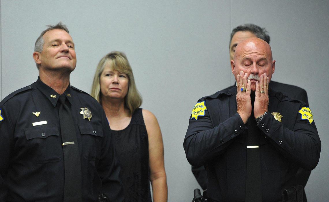 Fresno Bee photographer John Walker received first place in best news/feature photo in the 2019 George F. Gruner Awards contest for this shot of retiring Fresno Police Chief Jerry Dyer, right, and interim Chief Andy Hall, left, taken at the news conference announcing the change.