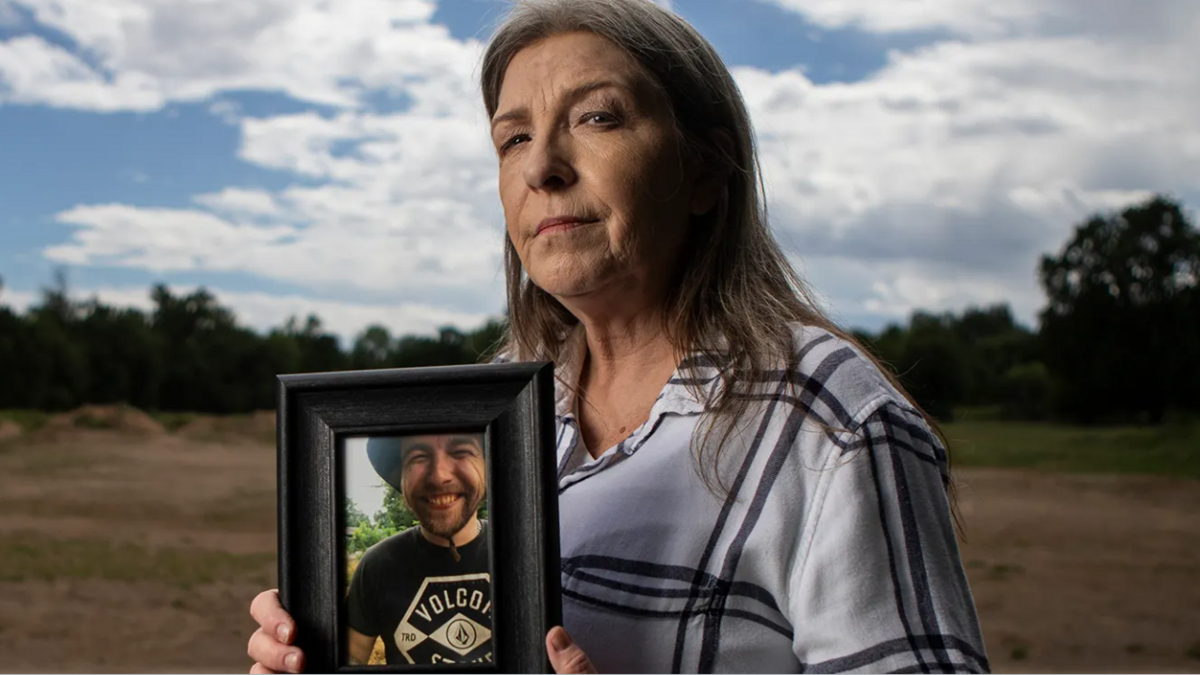 Jeanelle Couch holds a photo of her son, David Couch, while standing in Cascade Park in Redding on April 8, 2026. David Couch was killed in a shooting involving a California Highway Patrol officer in front of his home in February 2023.