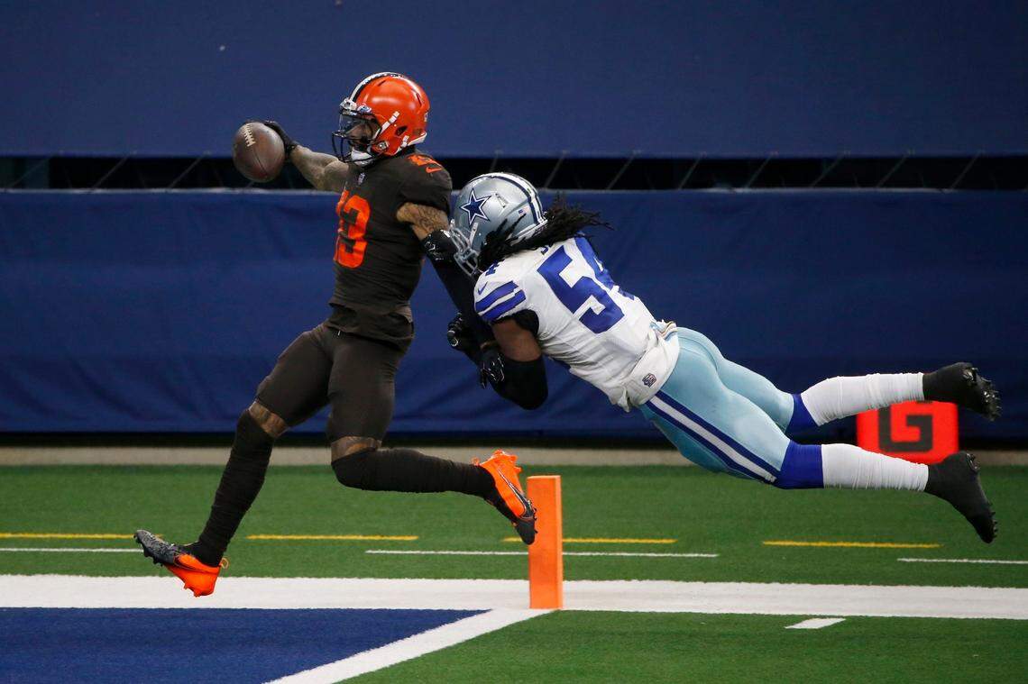 FILE - Cleveland Browns wide receiver Odell Beckham Jr. (13) scores a touchdown after a long run as Dallas Cowboys linebacker Jaylon Smith (54) attempts the stop in the second half of an NFL football game in Arlington, Texas, Sunday, Oct. 4, 2020. Odell Beckham Jr. is being released by the Cleveland Browns, who are cutting ties with the polarizing star wide receiver and have officially ended his drama-filled stay with the team.