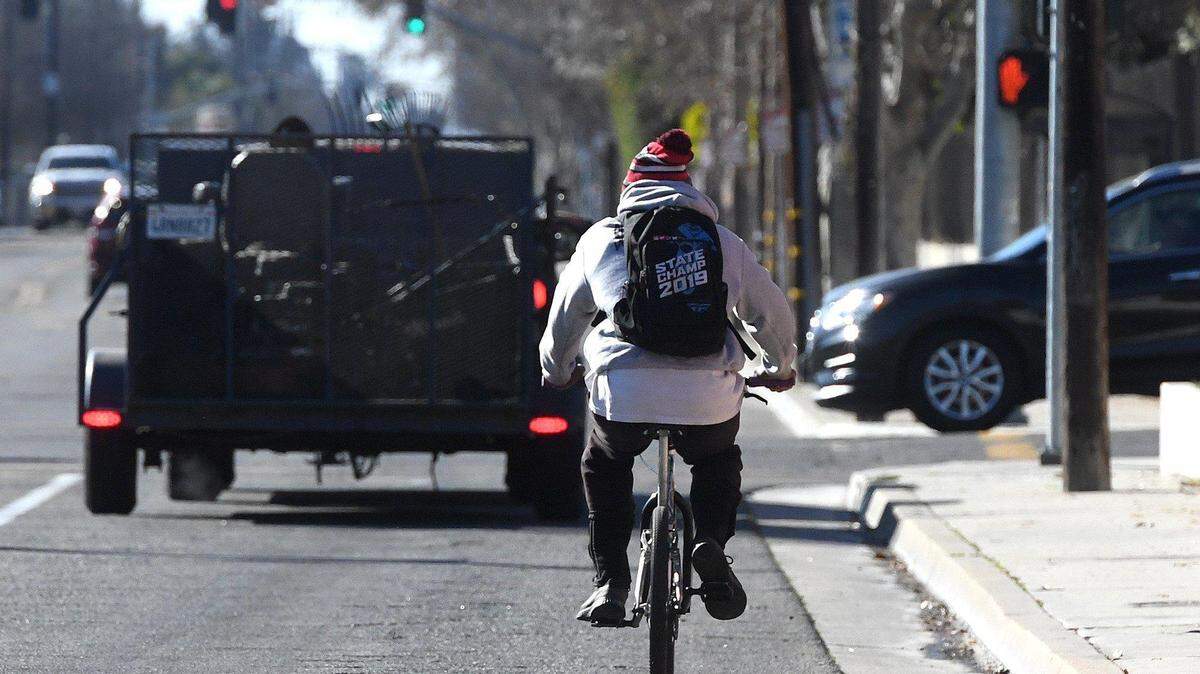 A cyclist rides on Palm Avenue south of Dakota Avenue. Reducing traffic fatalities for cyclists and pedestrians is a goal of planning called vision zero.