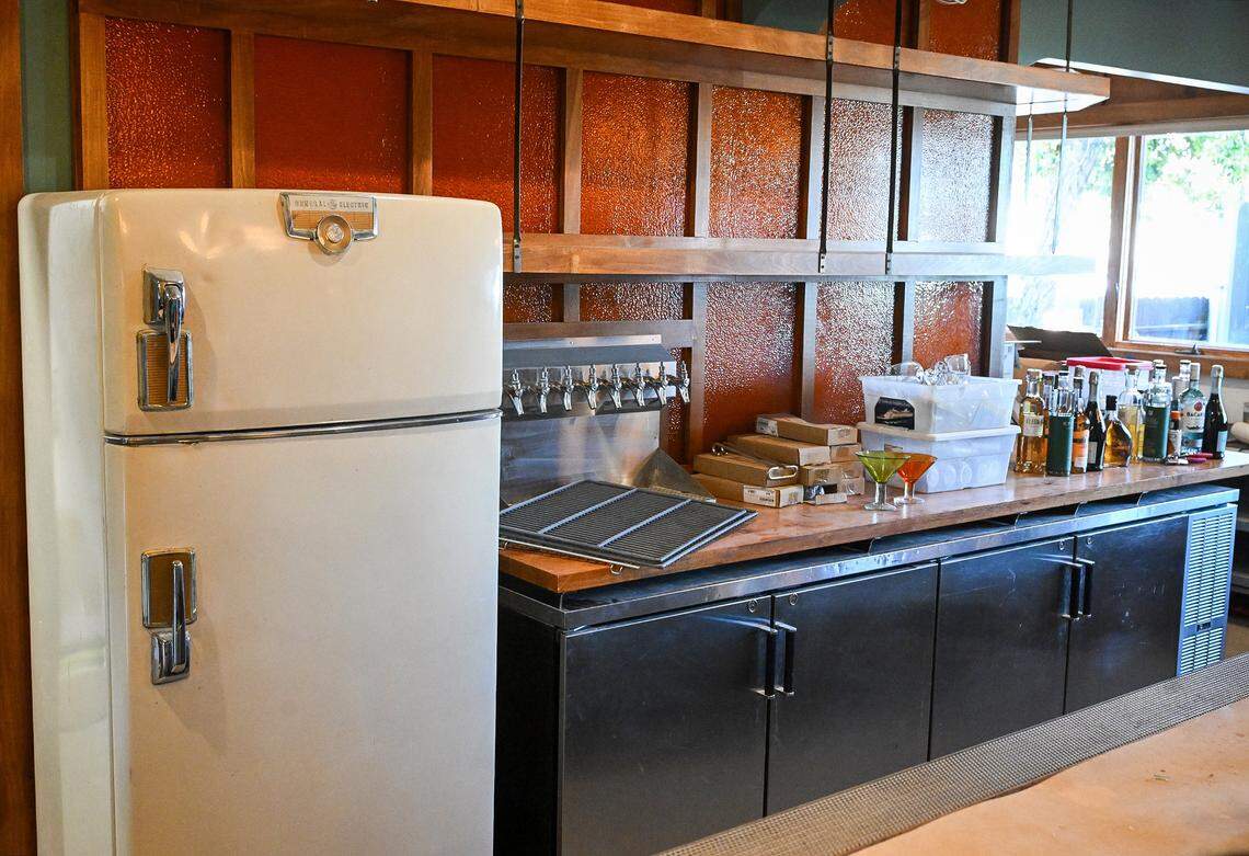 The main downstairs bar at Moses McQueen’s has a 1960s kitchen look because, owners say, that’s the place where everybody tends to hang out at parties.