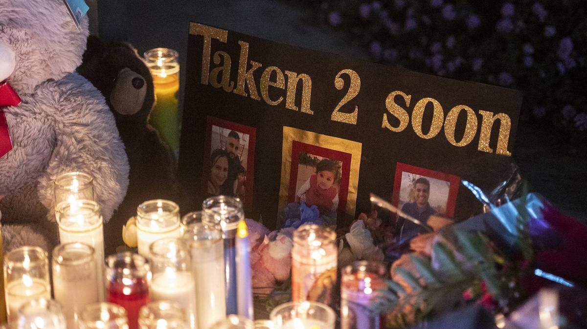 Photos of 8-month-old Aroohi Dheri, her parents Jasleen Kaur, 27, and Jasdeep Singh, 36, and her uncle Amandeep Singh, 39, are displayed during a vigil at Bob Hart Square in Merced, Calif., on Thursday, Oct. 6, 2022. The bodies of the four kidnapping victims were found in a rural area of Merced County north of Dos Palos.