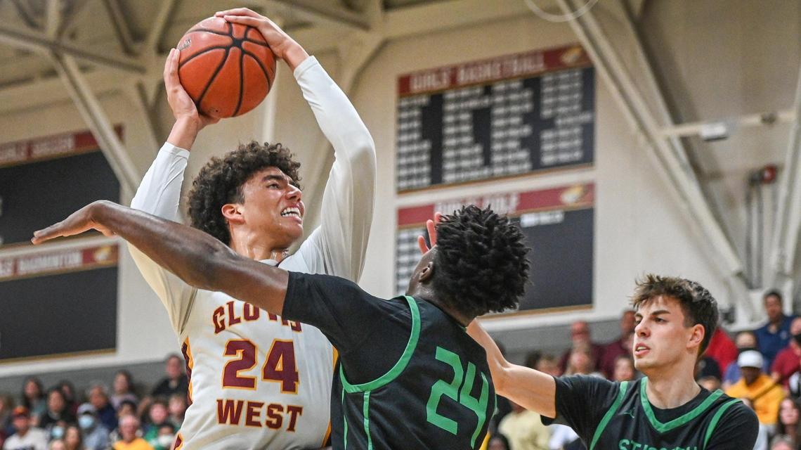 Clovis West’s Tyus Parrish-Tillman, left, goes up to the hoop while defended by St. Joseph’s Tounde Yessoufou, center, and David Vidor during their Central Section Open Division championship game at Clovis West on Saturday, Feb. 26, 2022.