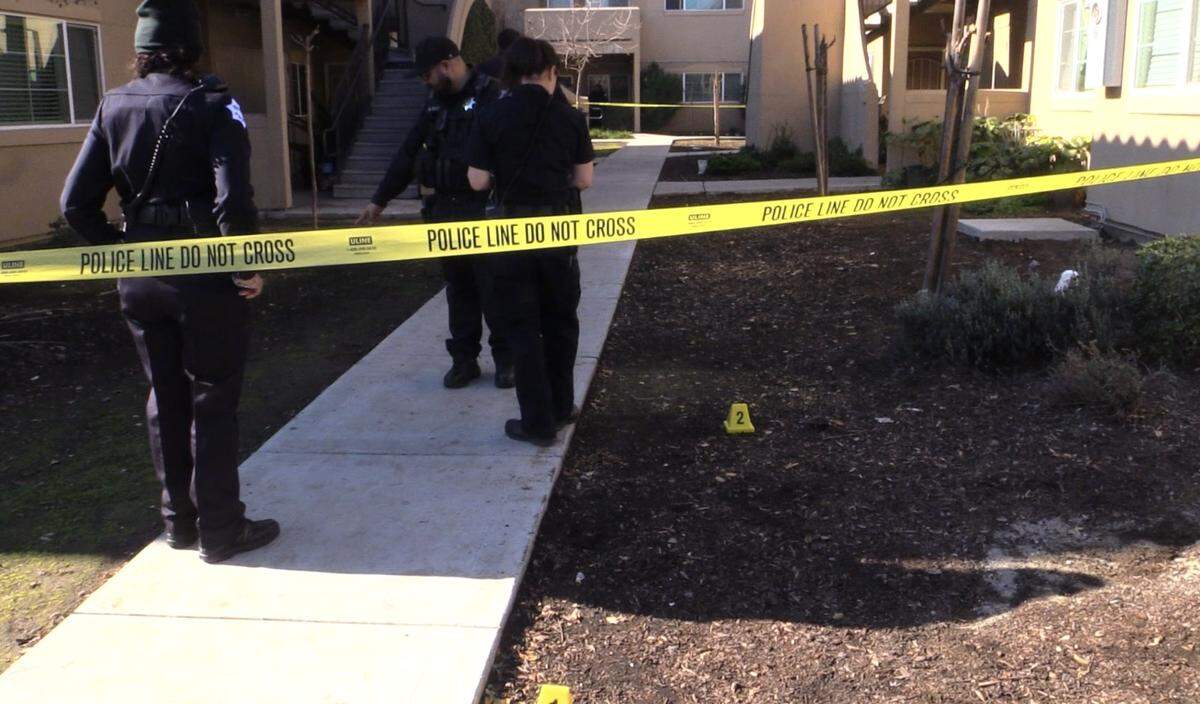 Evidence markers are placed after a shooting at a Fresno, California apartment complex on Sunday, Jan. 14, 2024.