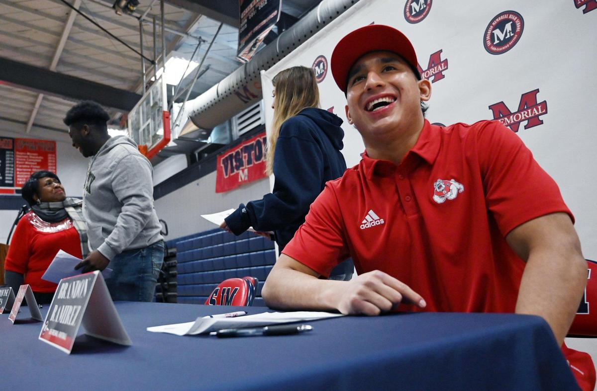 San Joaquin Memorial’s Brandon Ramirez, right, smiles after a signing ceremony to Fresno State Wednesday, Dec. 2, 2022 in Fresno.