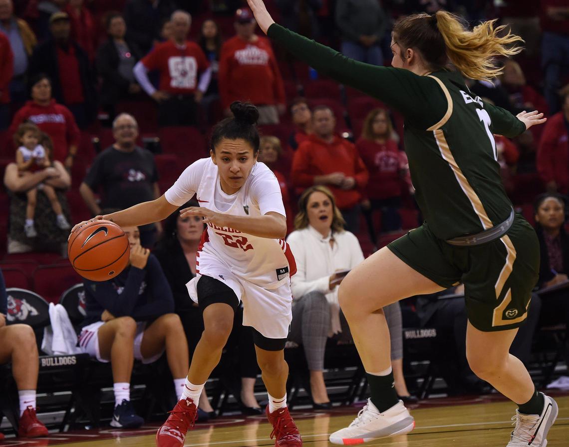Fresno State guard Aly Gamez, left, drives past Colorado State’s Makenzie Ellis in a victory over the Rams in January at the Save Mart Center. Gamez this season is averaging 10.6 points per game.