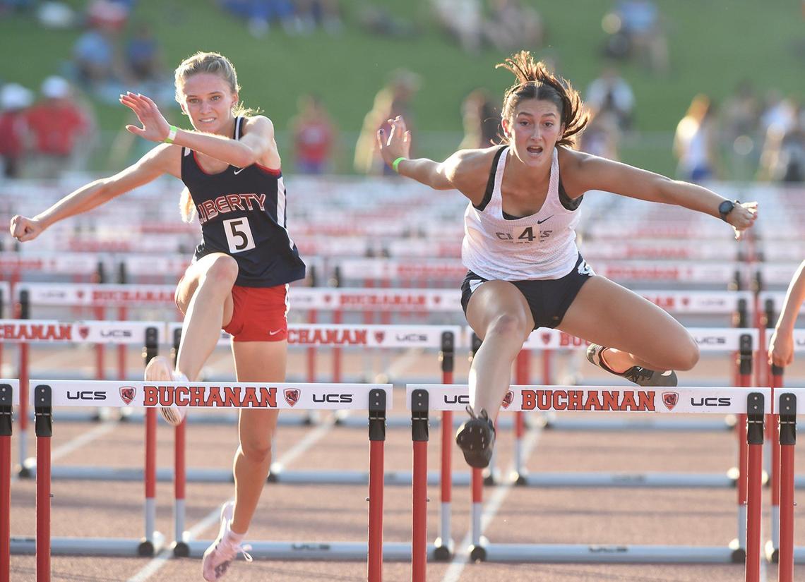 Clovis East’s Kylie Ward, right, competes in the Girls 100. High hurdles, ahead of Liberty-Bakersfield Bella Turner, during the CIF Central Section Masters Track and Field 2021 Championships at Buchanan High, Saturday June 19.