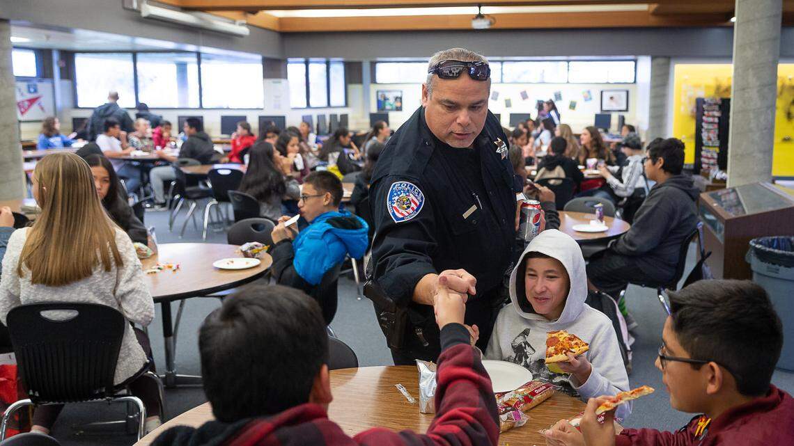 Officer Jesse Ceron, giving pre-COVID first bumps to students at Kastner Intermediate.