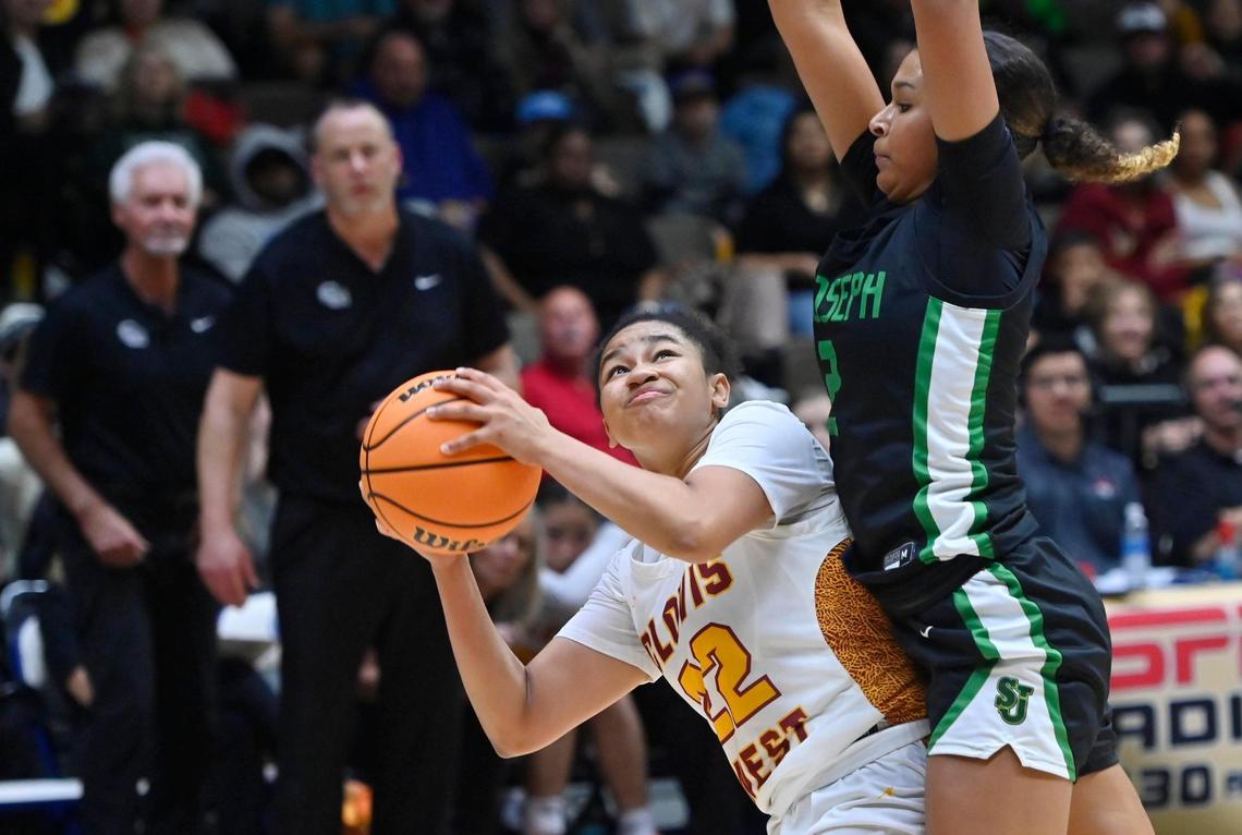 Clovis West’s Riley Wells, left, is fouled by St. Joseph’s Avary Cain, right, in the Division I Girls basketball championship Saturday, Feb. 24, 2024 at Selland Arena in Fresno. Final score, Clovis West 45, St. Jospeh 41.