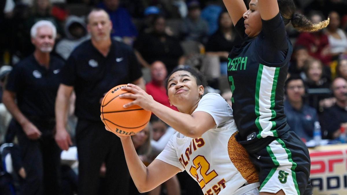 Clovis West’s Riley Wells, left, is fouled by St. Joseph’s Avary Cain, right, in the Division I Girls basketball championship Saturday, Feb. 24, 2024 at Selland Arena in Fresno. Final score, Clovis West 45, St. Jospeh 41.