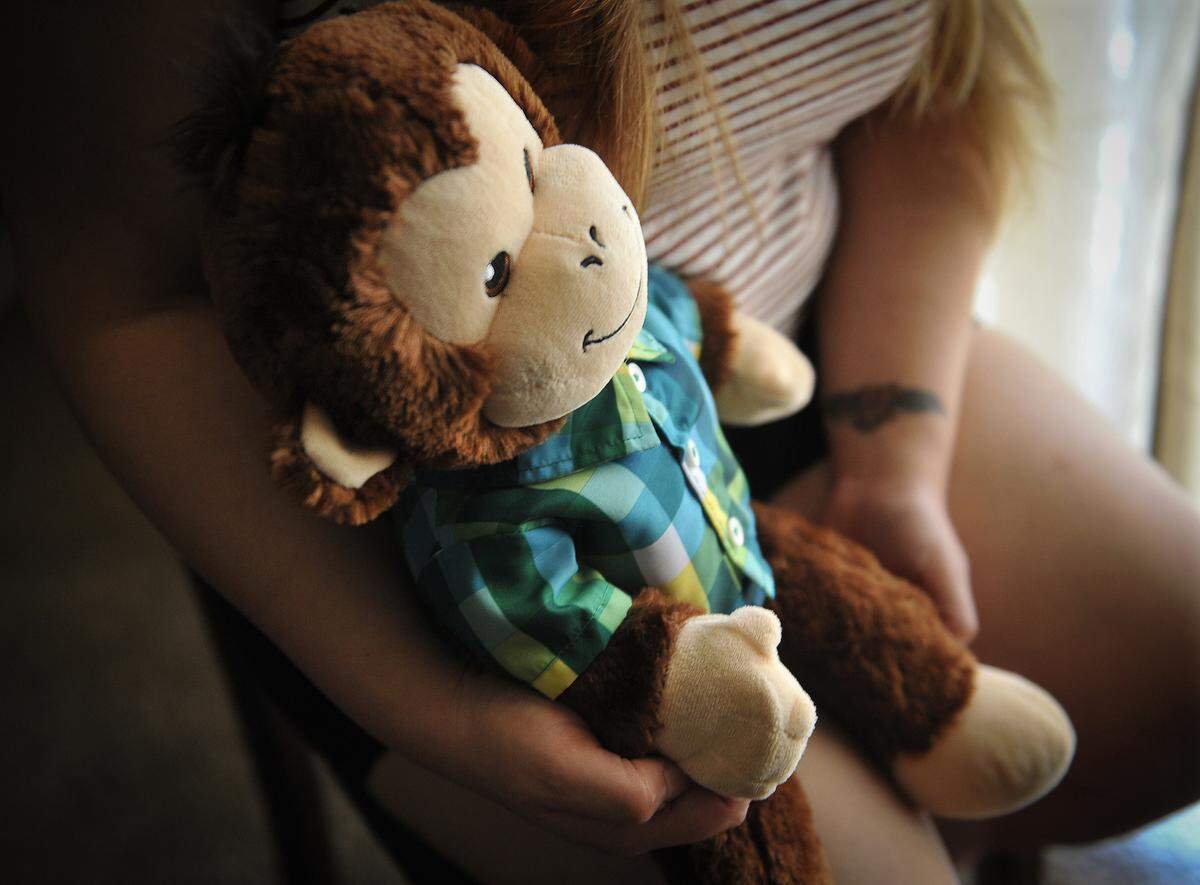 Jannette Maya holds her prized possession, a stuffed toy monkey given be her sister, Joanna Maya, who was murdered July 13, 2016, allegedly by the MS-13 gang in Mendota. Her sister’s nickname was “monkey.”