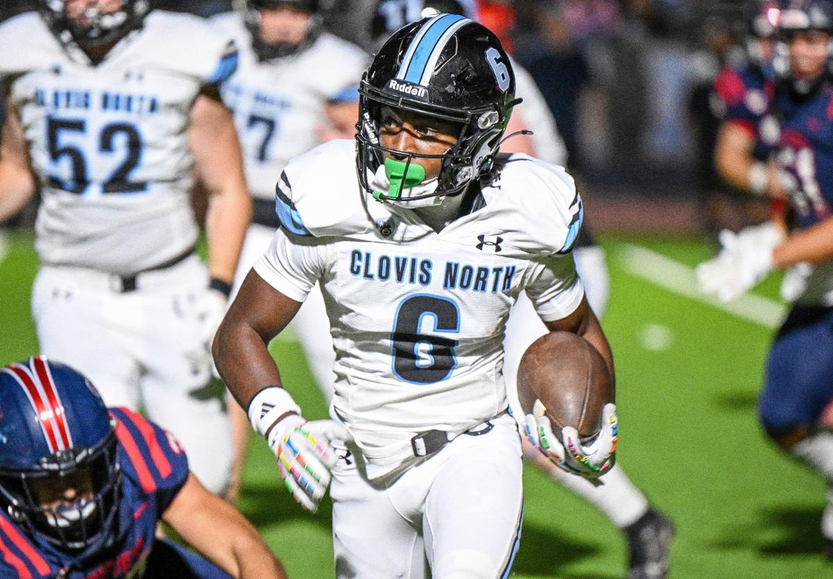 Clovis North wide receiver Tyree Sams looks for an opening while taking the ball down the sideline in the first half of their game against Memorial at San Joaquin Memorial on Friday, Aug. 23, 2024.