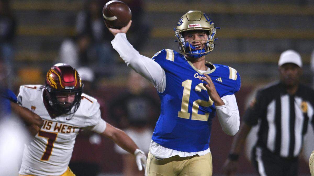 Clovis High quarterback Deagan Rose throws as Clovis West'sZachary Fortier rishes from the left Friday, Oct. 31, 2025 in Clovis. Clovis High led 21-10 at halftime.
