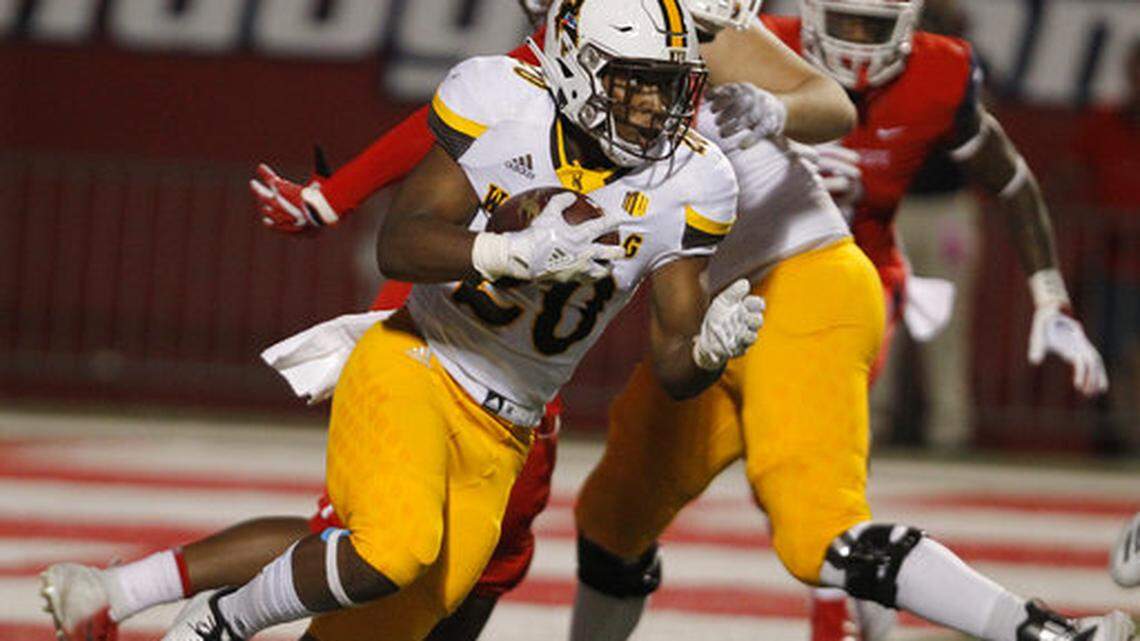 Wyoming running back Jevon Bigelow looks for room to run against Fresno State defenders during the October 2018 meeting in Fresno, Bigelow, a Central High product, has transferred to Fresno State.