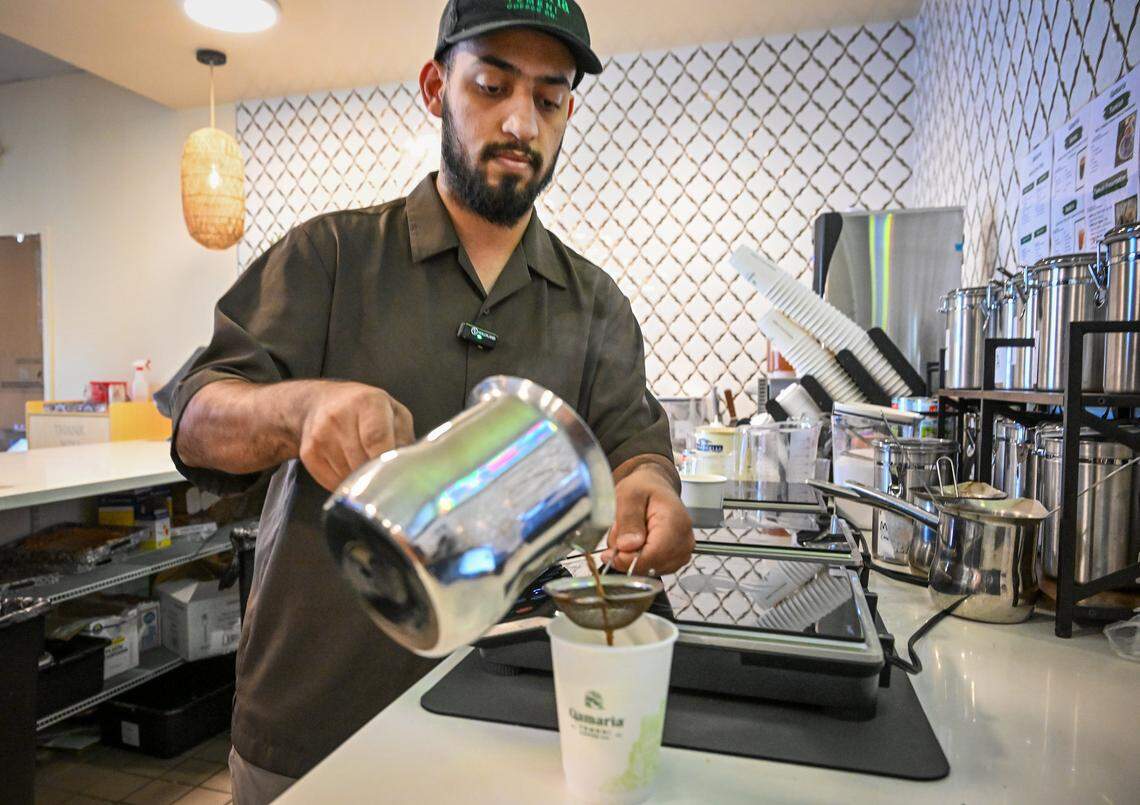 Nagi Alazani prepares a cup of Yemeni coffee at Qamaria Yemeni Coffee Co., which he recently opened in the Marketplace at El Paseo with Shehab Zamzami. 