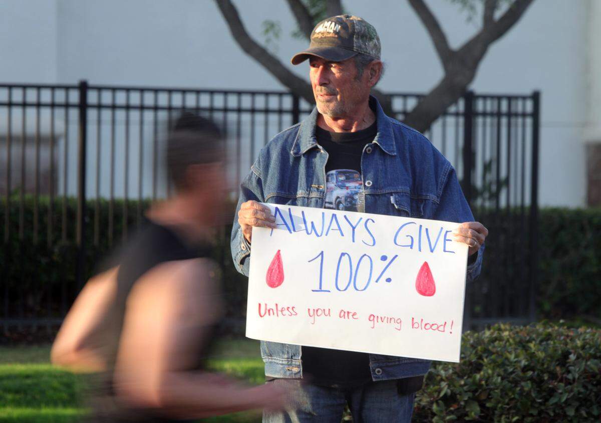 A spectator motivates participants of the Two Cities Marathon on Nov. 5, 2023.