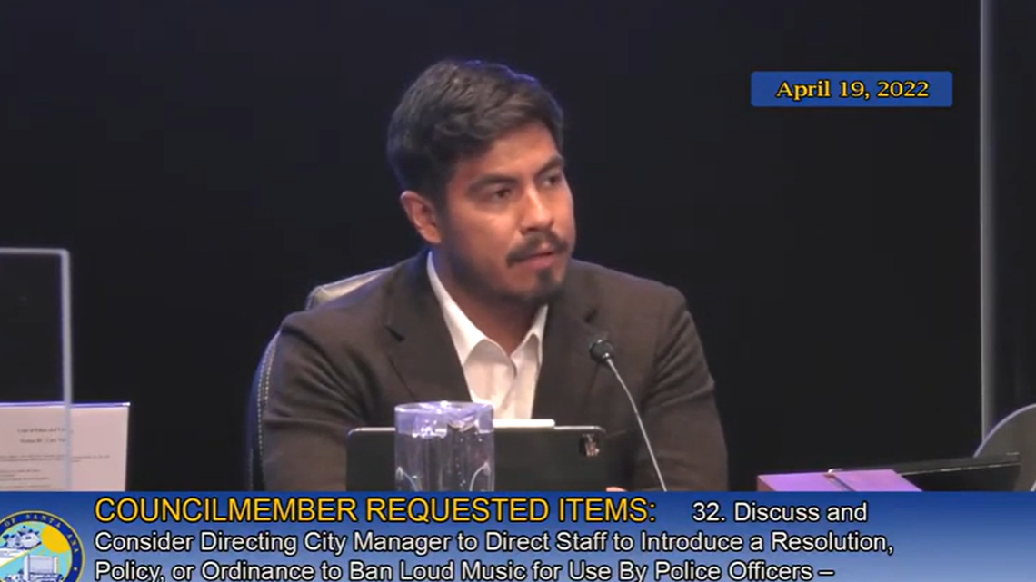 Santa Ana City Councilman Johnathan Ryan Hernandez is shown discussing a proposed ban on officers playing loud music to deter the public from recording them at an April 19 meeting. Officers blared Disney music on April 4 to stop a YouTuber from posting his videos online.