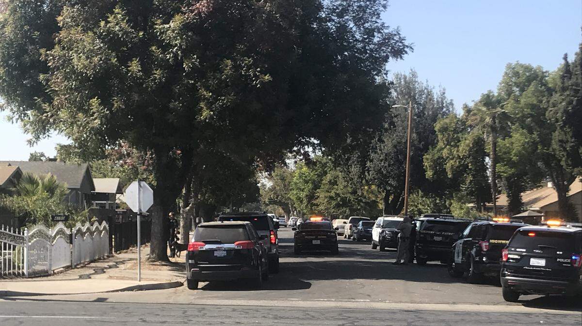 CHP officers and Fresno police surround home where a stolen car suspect ran on Tuesday, Oct. 15, 2019.
