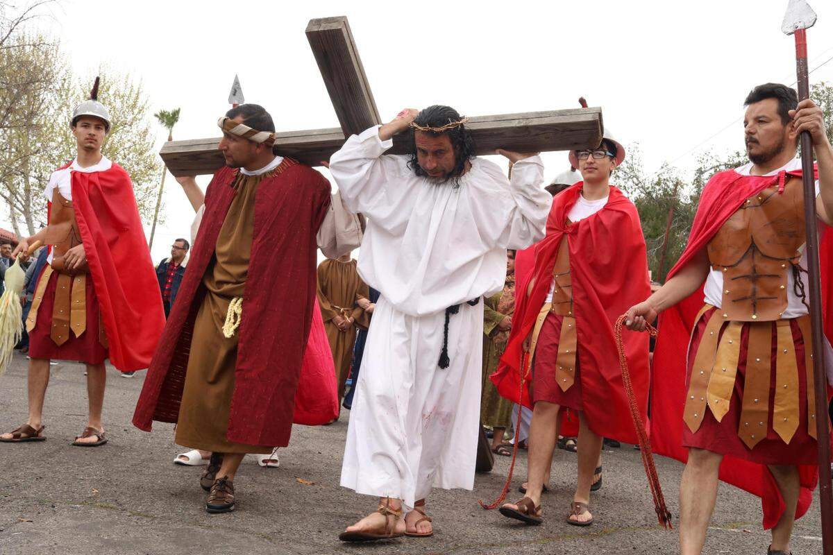 Luis Alberto Hernández as Jesús with other members of the church’s Recollection young adult group during the Live Stations of the Cross at Saint Anthony Mary Claret Catholic church on Good Friday, March 29, 2024, in Fresno.