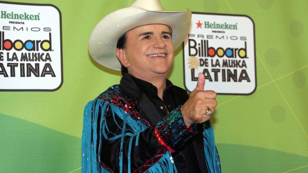 Tejano music television host Johnny Canales waves to photographers backstage at the 2005 Billboard Latin Music Awards. He died June 13, 2024.