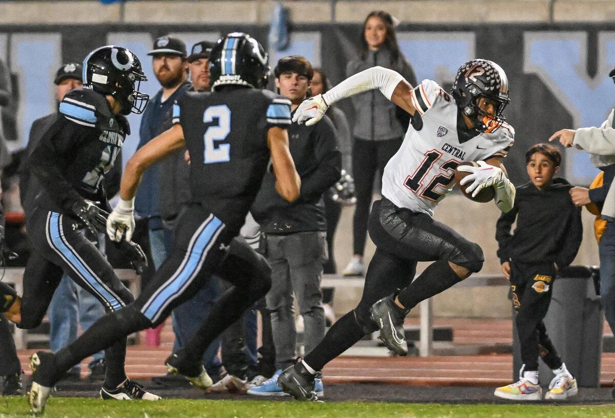 Central’s Noel Felix III, right, tries to get a few more yards up the sideline after a catch against Clovis North in their Central Section Division 1 football championship game at Veterans Memorial Stadium in Clovis on Friday, Nov. 24, 2023.