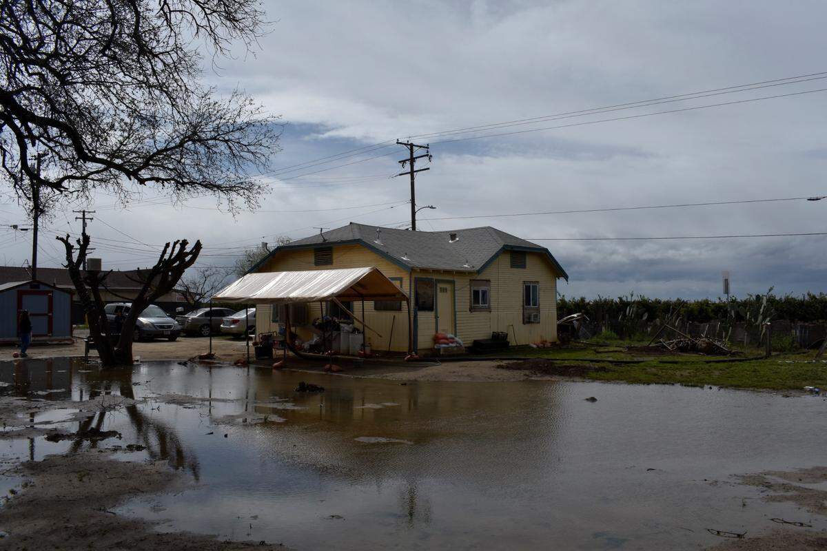 Water sat in the Hernandez family home’s backyard after it flooded in Toolville, a Census-designated community in rural Tulare County, on March 22, 2023. Family members said they are concerned about potential pesticide and fertilizer pollution in their yard since their home is very few feet away from citrus fields.