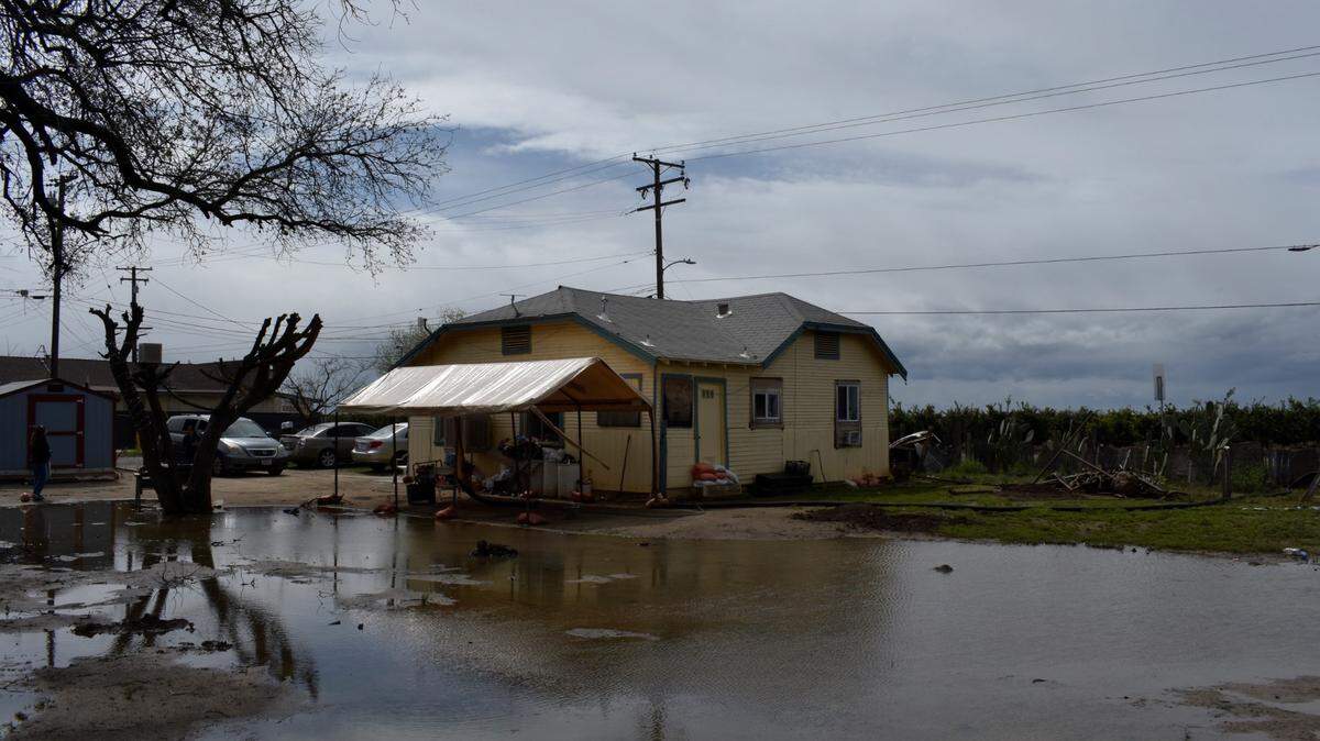 Water sat in the Hernandez family home’s backyard after it flooded in Tooleville, a Census-designated community in rural Tulare County, on March 22, 2023. Family members said they are concerned about potential pesticide and fertilizer pollution in their yard since their home is very few feet away from citrus fields.