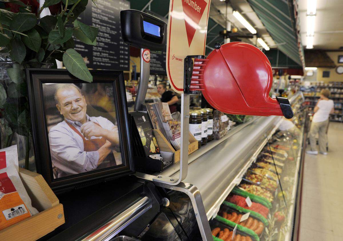 Sam Marziliano is shown in a framed photograph near where customers are encouraged to take a number at Sam’s Italian Deli and Market in this file photo from 2014. Sam Marziliano died in March 2011 but the deli continues.